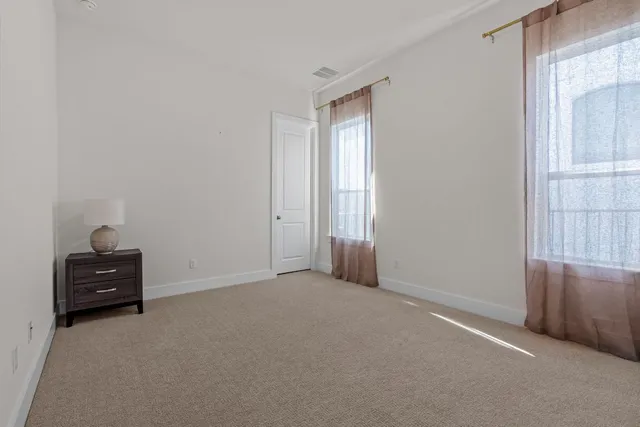 a view of an empty room and a window