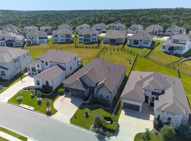 an aerial view of a house with a swimming pool outdoor seating and yard