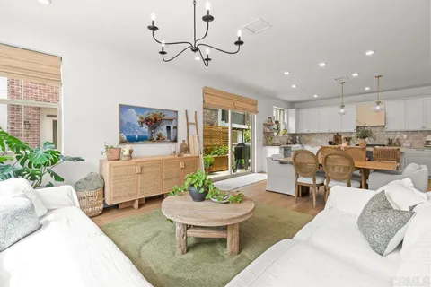 a dining room with furniture and a large window