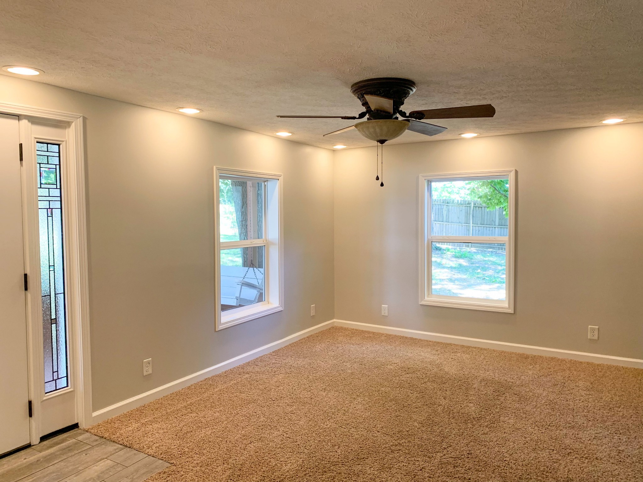 125 Corinth Road Portland, TN 37148 - Photo 13 of 30 an empty room with windows and a ceiling fan