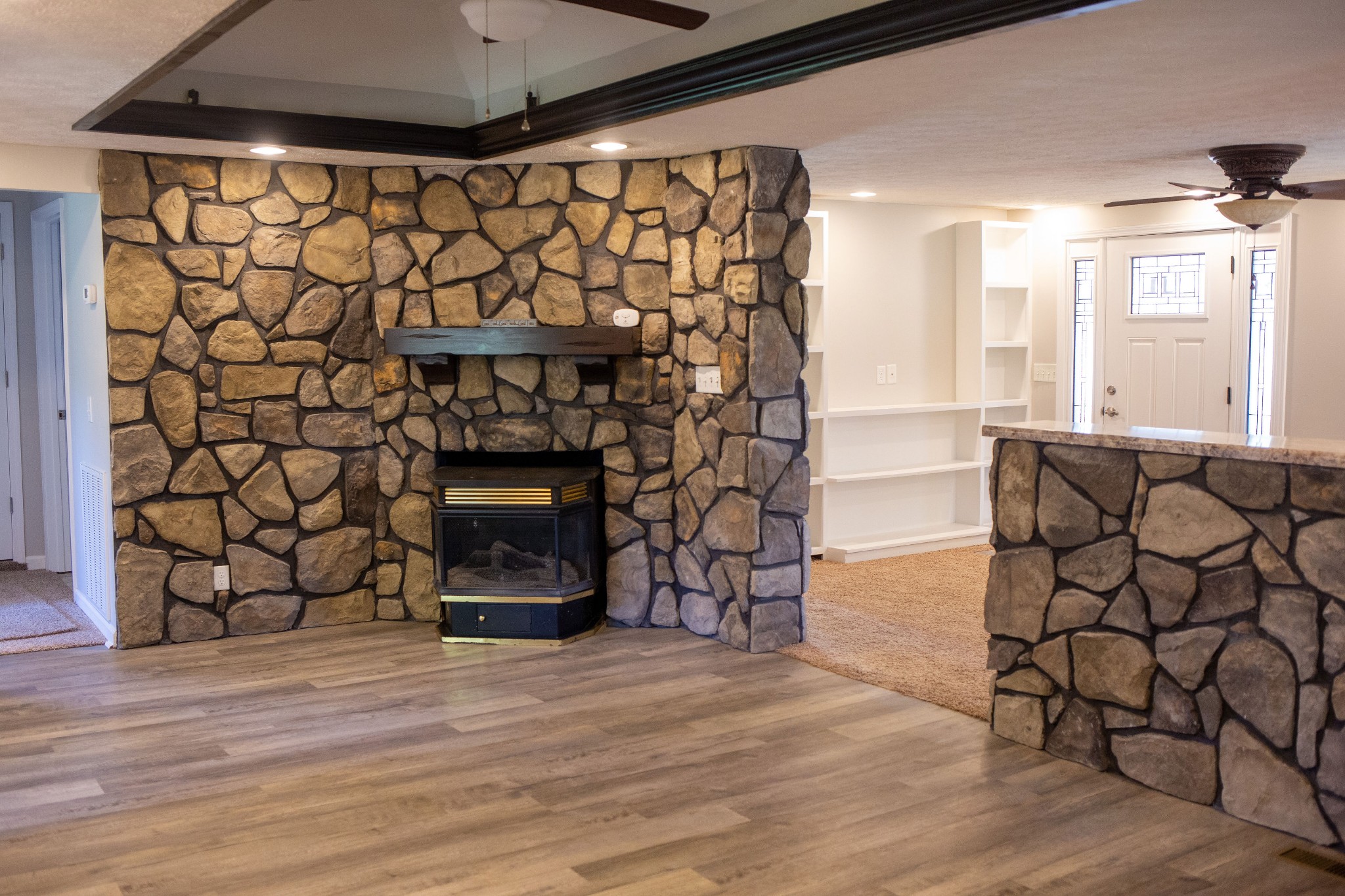 125 Corinth Road Portland, TN 37148 - Photo 20 of 30 a living room with a wooden floor and a fireplace