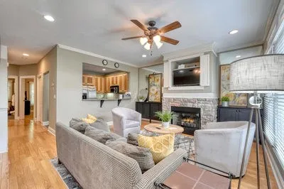 a living room with furniture a fireplace and a flat screen tv