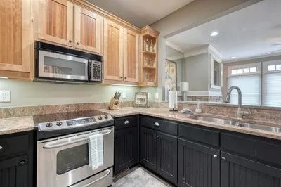 a spacious bedroom with a bed and a chandelier