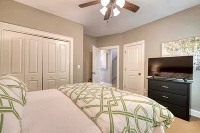 a bedroom with a bed and a television