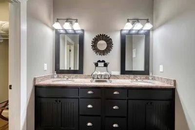 a bathroom with a granite countertop sink a large mirror and a shower