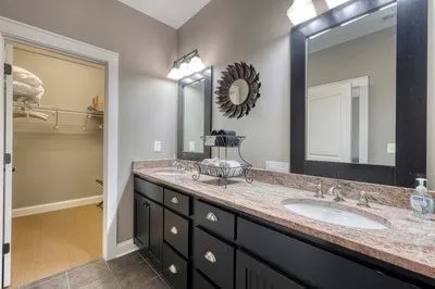 a bathroom with a tub a sink and a shower