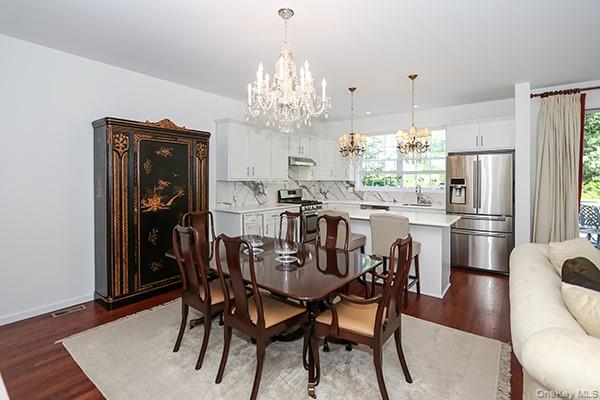 4 Spring Court Huntington, NY 11743 - Photo 12 of 38 a view of a dining room with furniture a chandelier and wooden floor