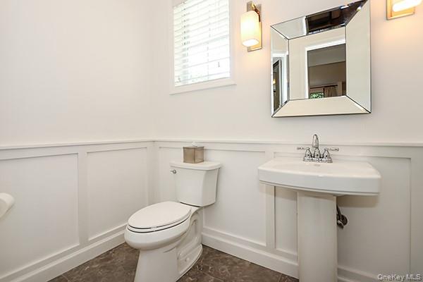 4 Spring Court Huntington, NY 11743 - Photo 13 of 38 a bathroom with a sink a mirror and a toilet