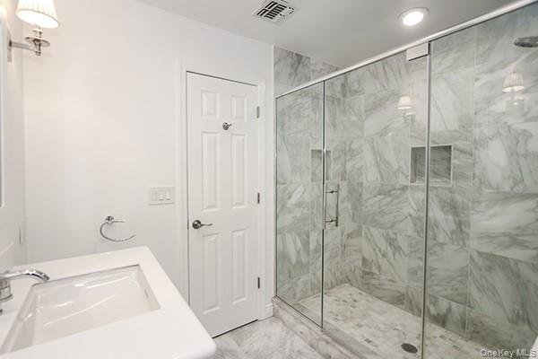 4 Spring Court Huntington, NY 11743 - Photo 17 of 38 a bathroom with a shower and a sink