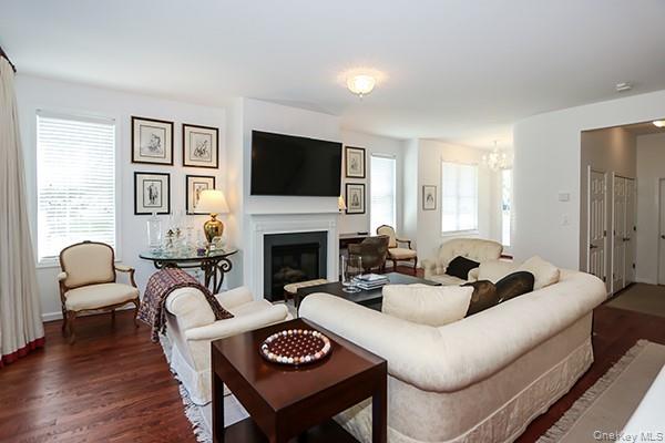 4 Spring Court Huntington, NY 11743 - Photo 7 of 38 a living room with furniture a fireplace and a flat screen tv
