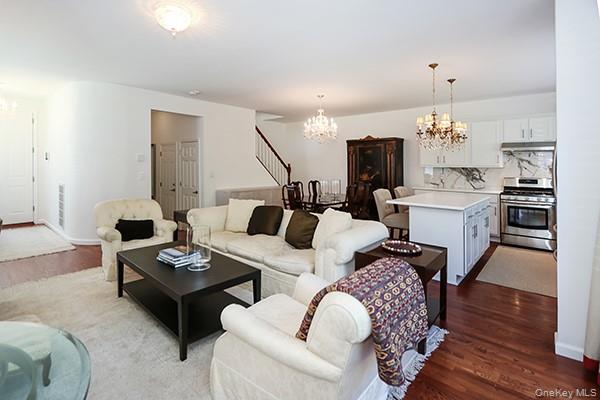4 Spring Court Huntington, NY 11743 - Photo 8 of 38 a living room with fireplace furniture and a wooden floor