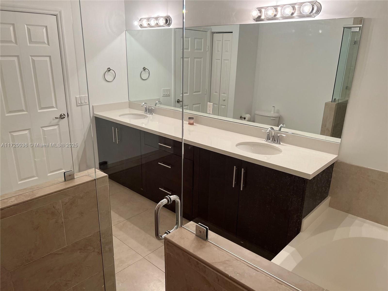 Doral Doral, FL 33178 - Photo 19 of 32 a bathroom with a sink and a mirror