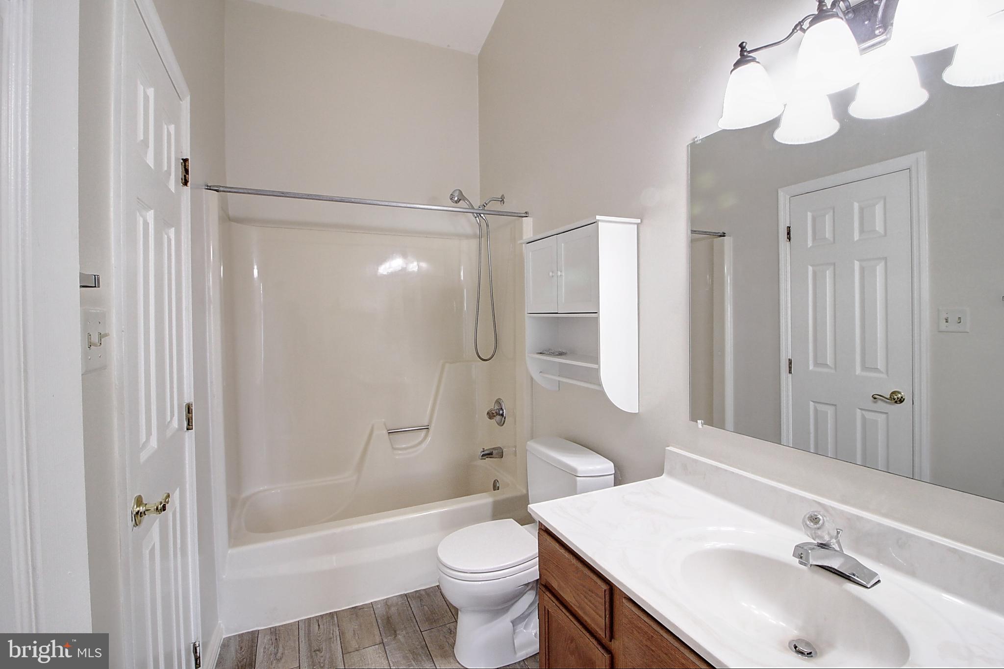 42 Victoria Square Frederick, MD 21702 - Photo 20 of 21 a bathroom with a sink a toilet and shower