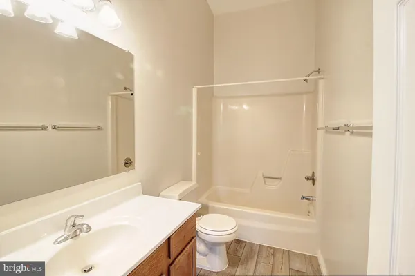 a bathroom with a sink mirror toilet and bathtub