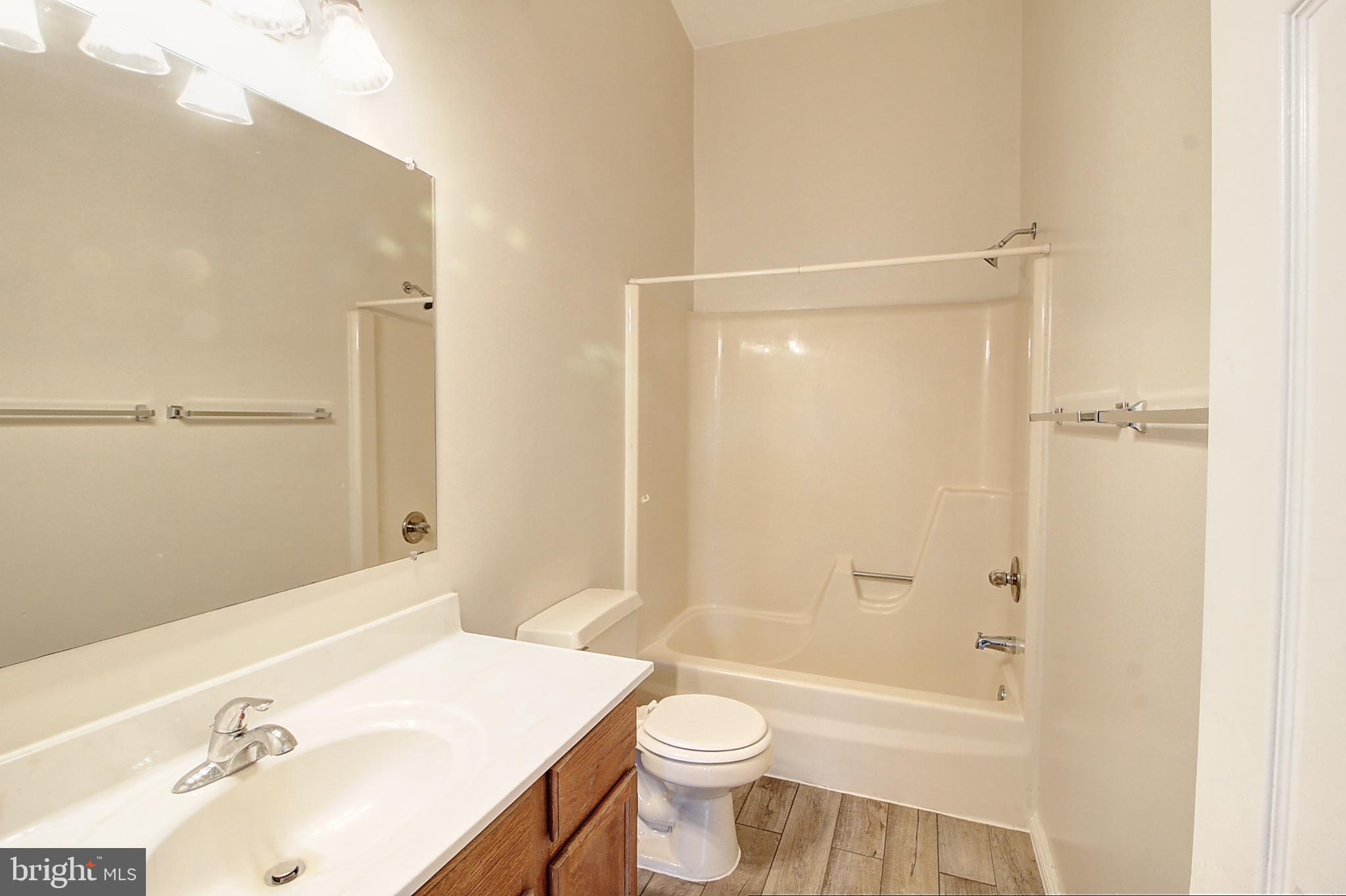 42 Victoria Square Frederick, MD 21702 - Photo 21 of 21 a bathroom with a sink mirror toilet and bathtub