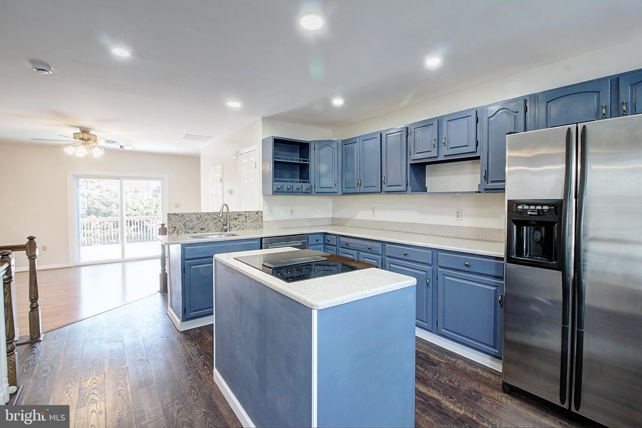 42 Victoria Square Frederick, MD 21702 - Photo 3 of 21 a kitchen with a refrigerator a sink and wooden cabinets