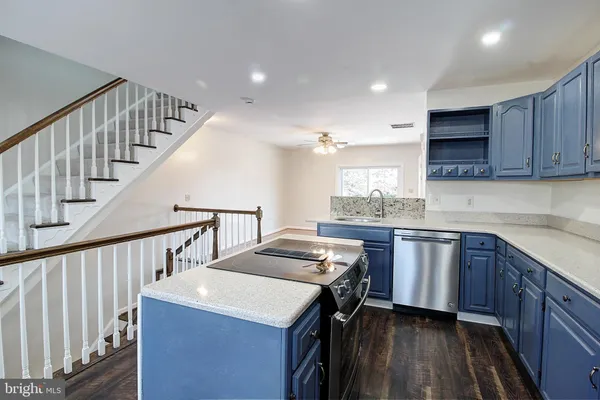 a kitchen with sink cabinets and stove