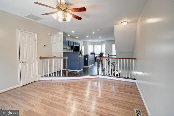 a view of kitchen with furniture and a ceiling fan