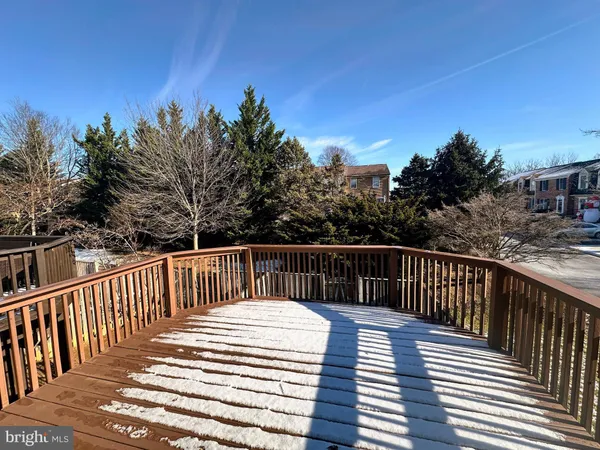a balcony with wooden floor and fence