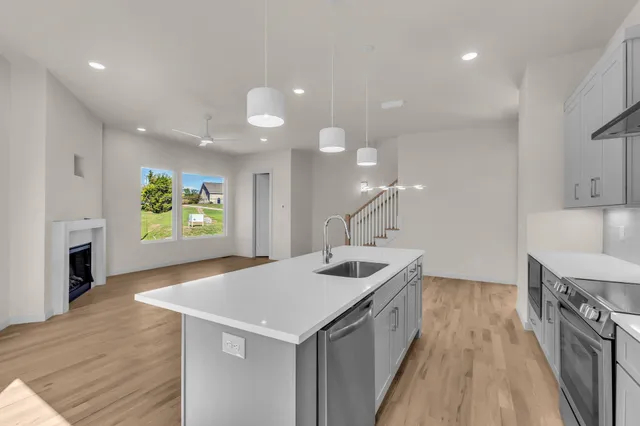 a kitchen with a sink and a stove top oven