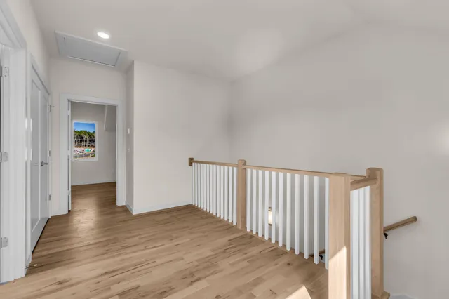 a view of a hallway with wooden floor