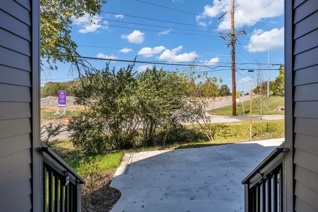 a view of a porch with a table and chairs