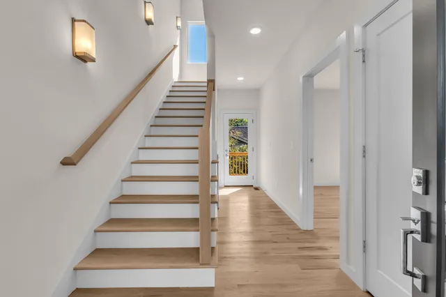 a view of entryway and hall with wooden floor