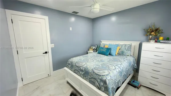 a bedroom with a bed and a dresser