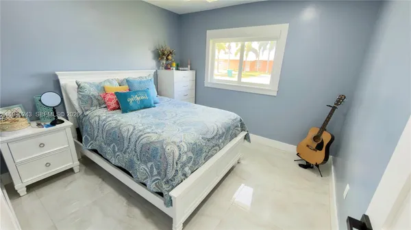 a bedroom with a bed and window