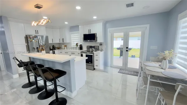 a kitchen with a sink cabinets and refrigerator