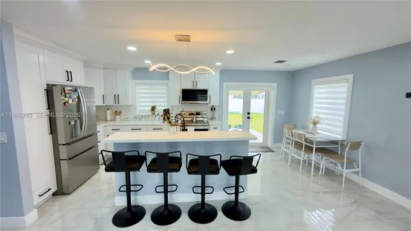 a kitchen with a dining table and chairs