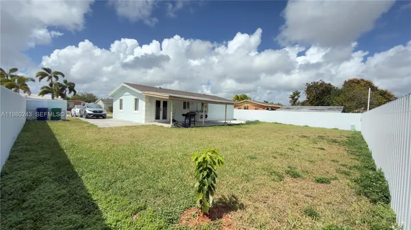 a view of house with yard