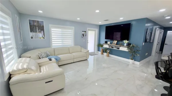 a living room with furniture and a flat screen tv