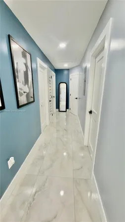 a large white bed in a white room