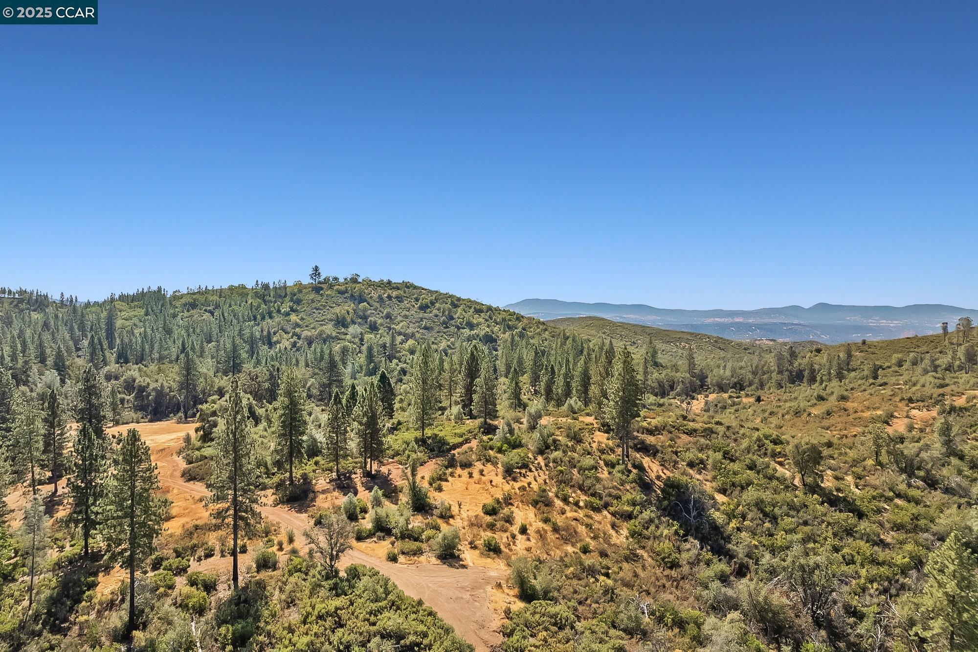 7559 Alamo Rd Mountain Ranch Mountain Ranch, CA 95246 - Photo 10 of 22 a view of a large building with mountains in the background