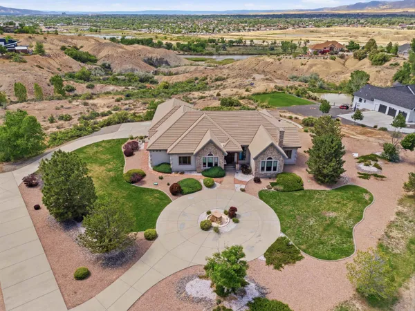 an aerial view of a house with a swimming pool yard and outdoor seating