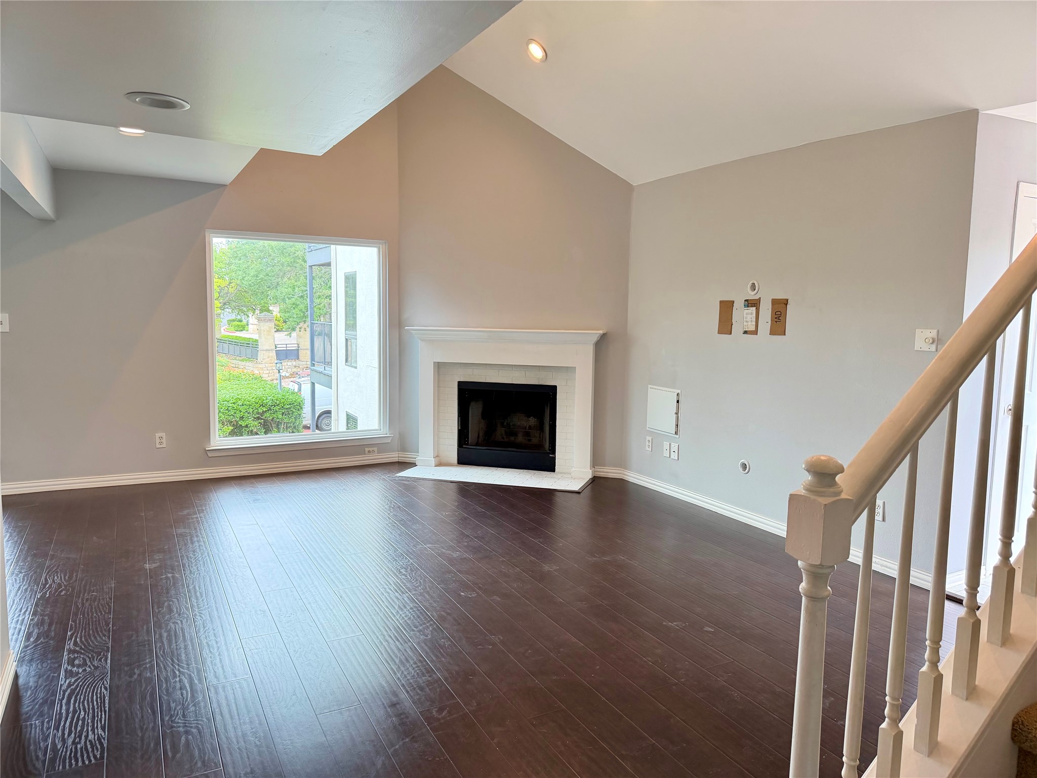 2918 Ranch Road 620 North, Unit C120 Austin, TX 78734 - Photo 8 of 34 A spacious living area offers rich hardwood flooring, a striking fireplace, and vaulted ceilings.