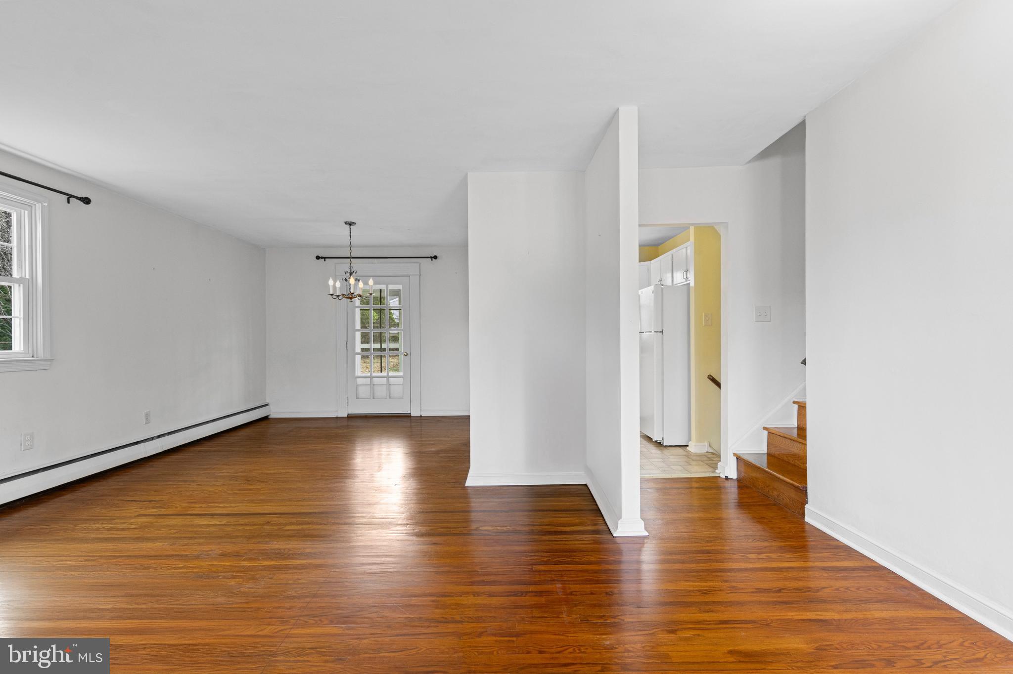 320 Landsende Road Devon, PA 19333 - Photo 3 of 26 a view of an empty room with window and wooden floor
