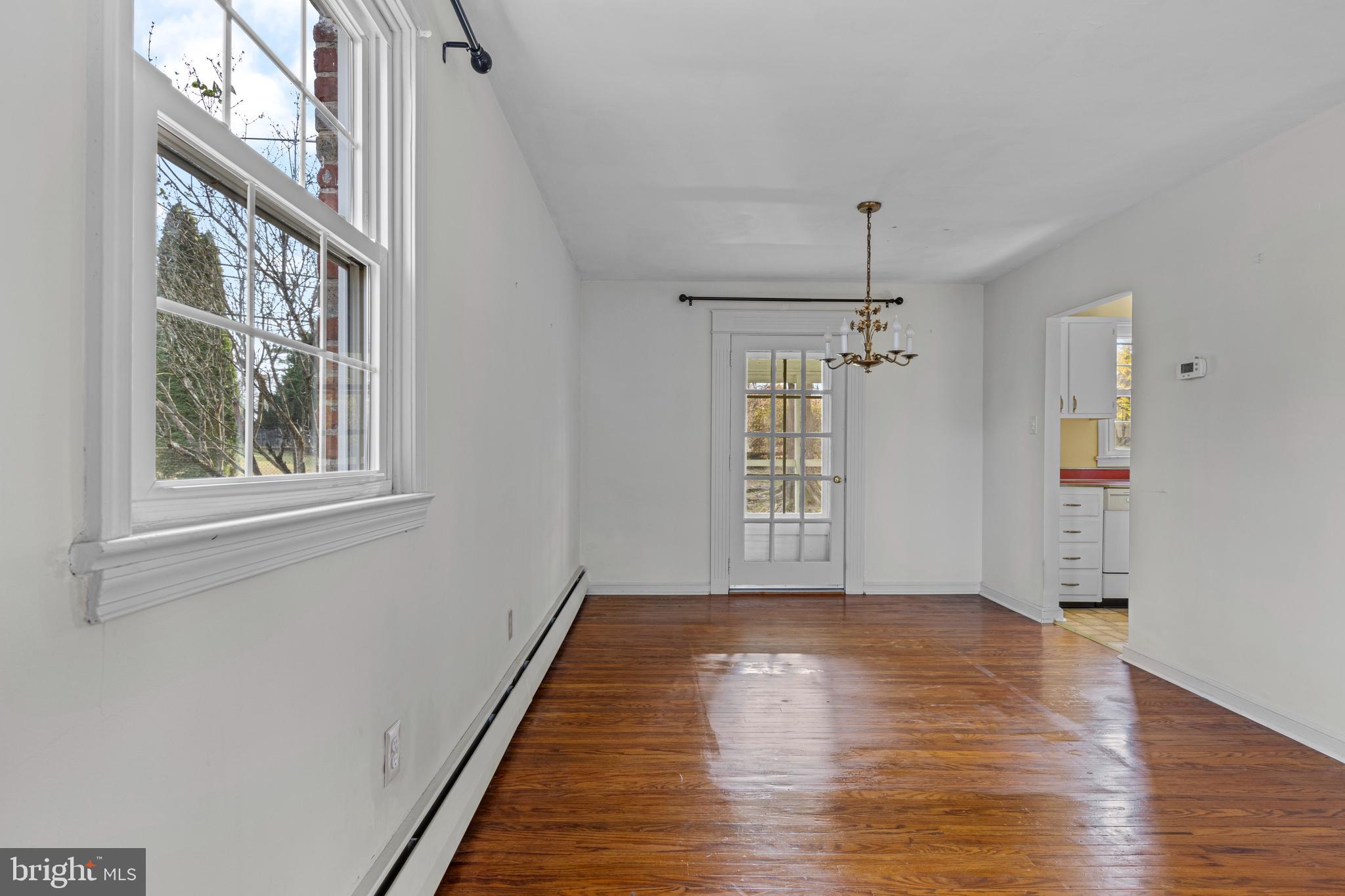 320 Landsende Road Devon, PA 19333 - Photo 8 of 26 a view of an empty room with wooden floor and a window
