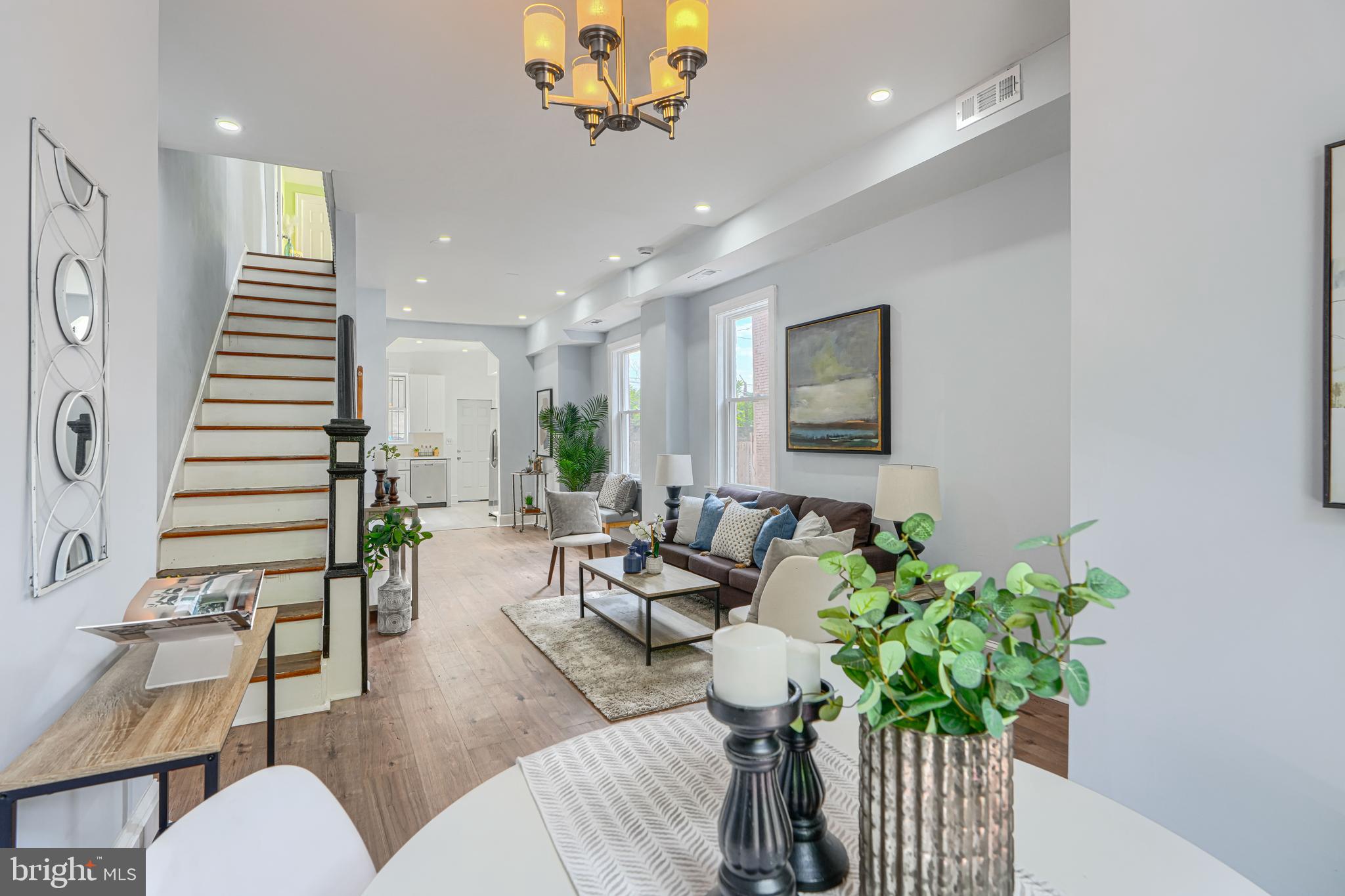 a living room with furniture flowerpot and wooden floor
