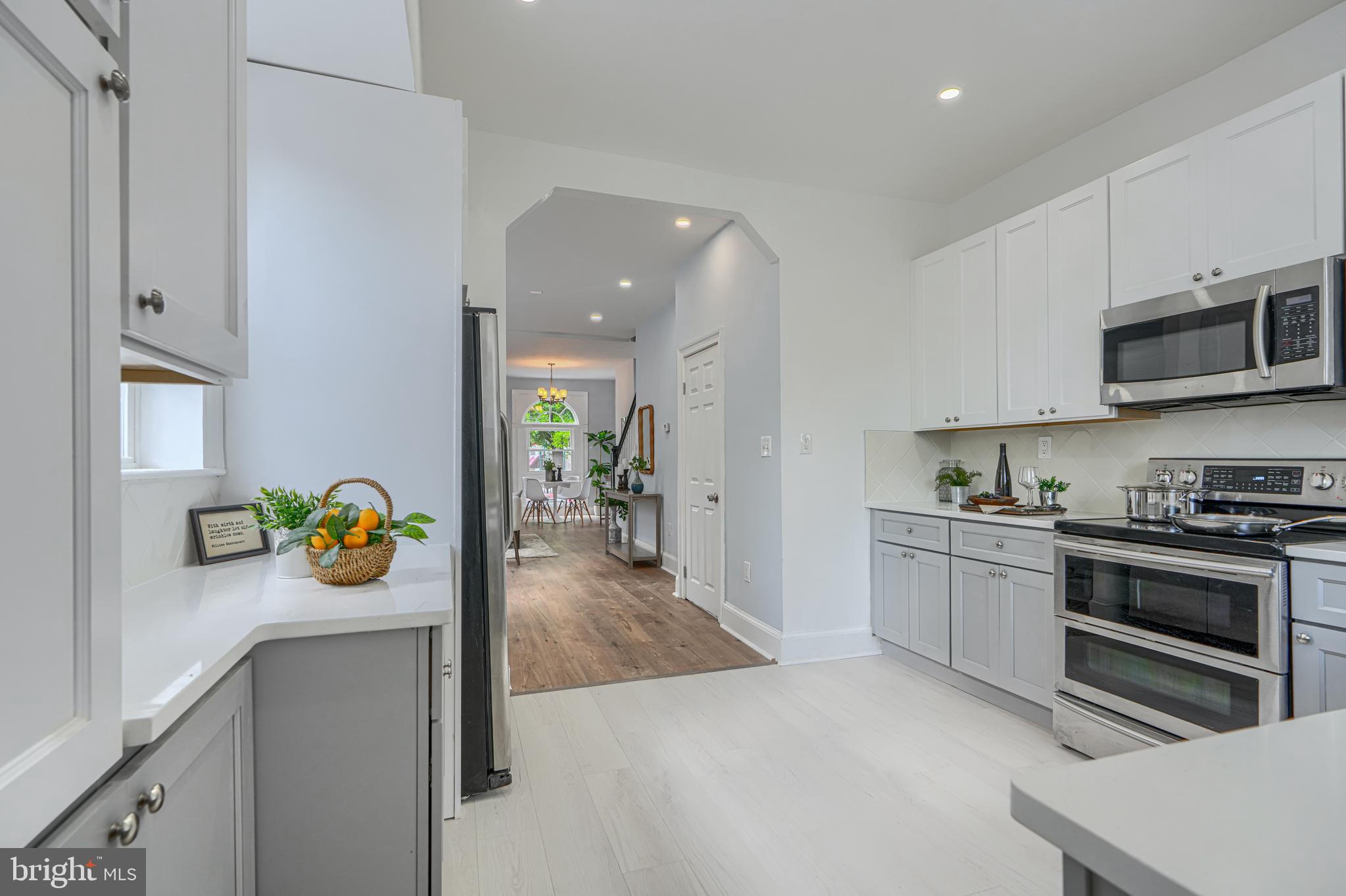 427 East 27th Street Baltimore, MD 21218 - Photo 13 of 24 a kitchen with stainless steel appliances stove and cabinets