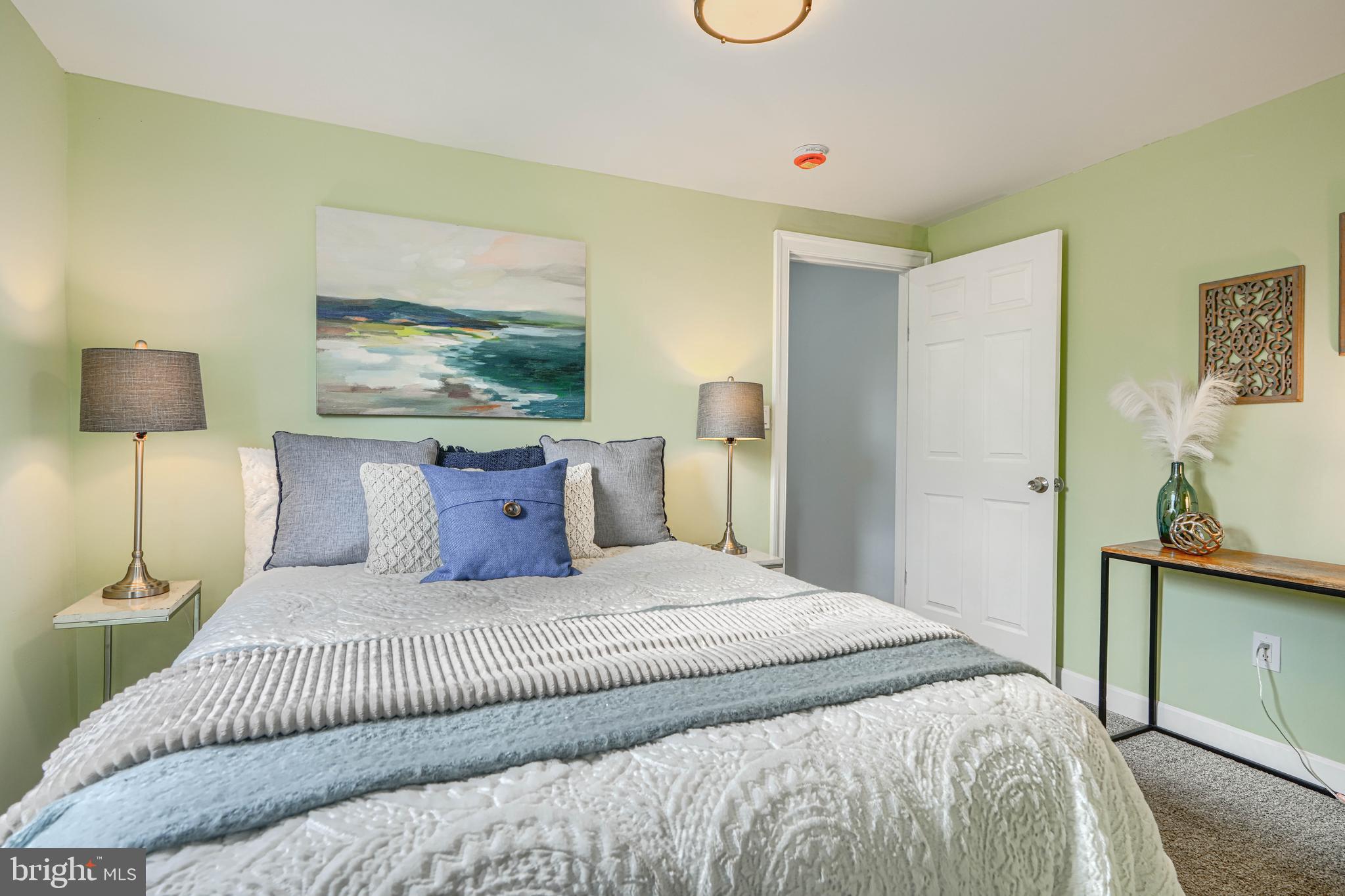 427 East 27th Street Baltimore, MD 21218 - Photo 14 of 24 a bedroom with a bed and a painting on the wall