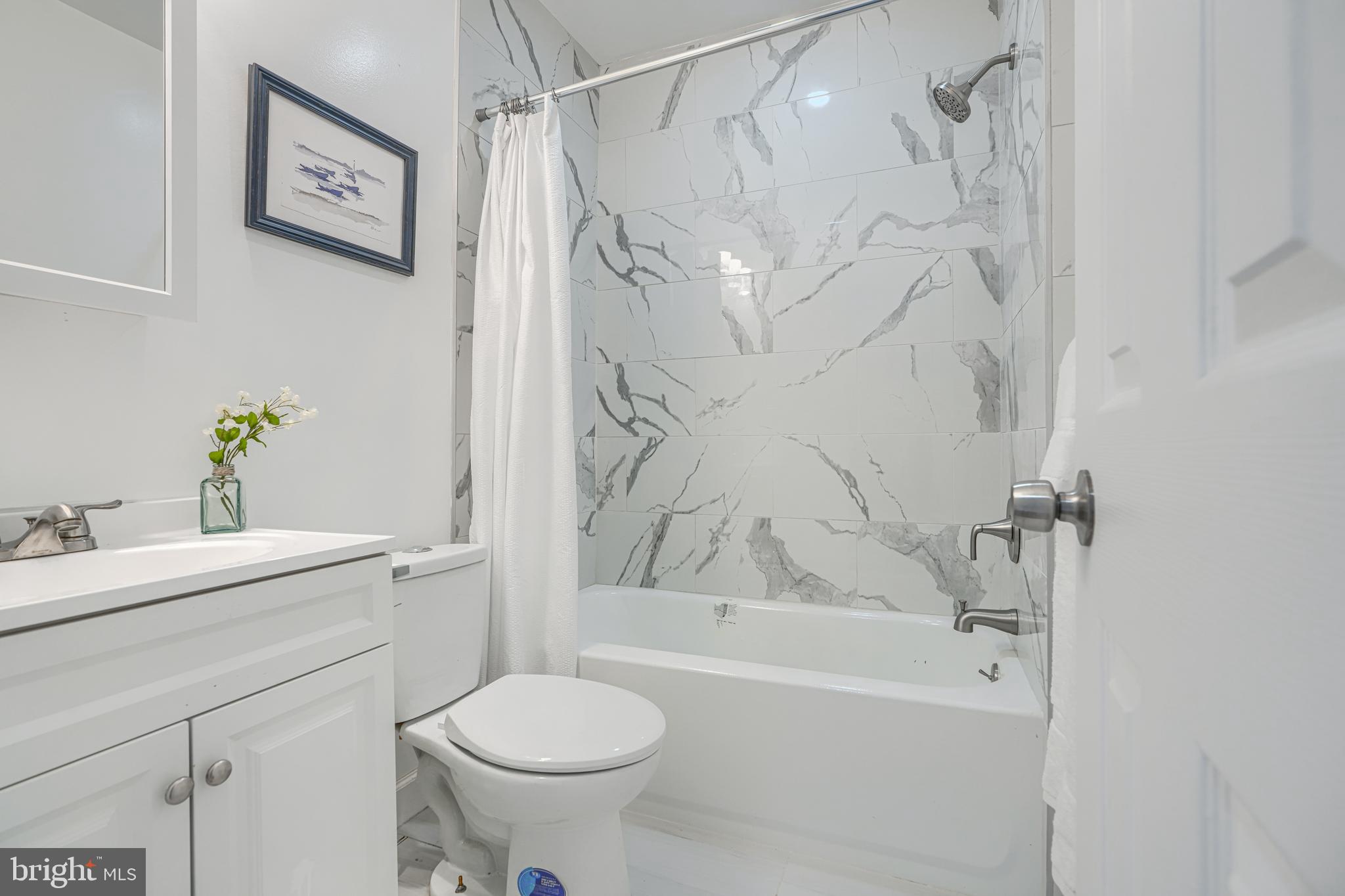 427 East 27th Street Baltimore, MD 21218 - Photo 19 of 24 a bathroom with a sink toilet and shower