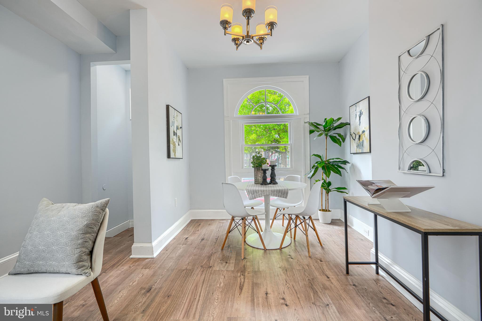 427 East 27th Street Baltimore, MD 21218 - Photo 3 of 24 a view of a dining room with furniture and a window