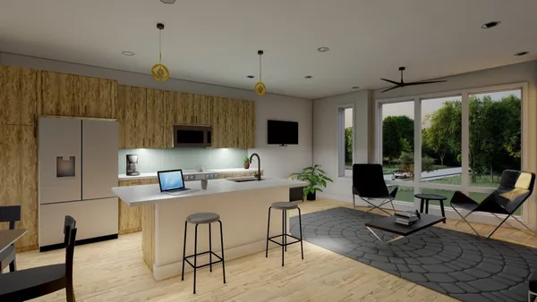 a view of a livingroom with furniture and a kitchen