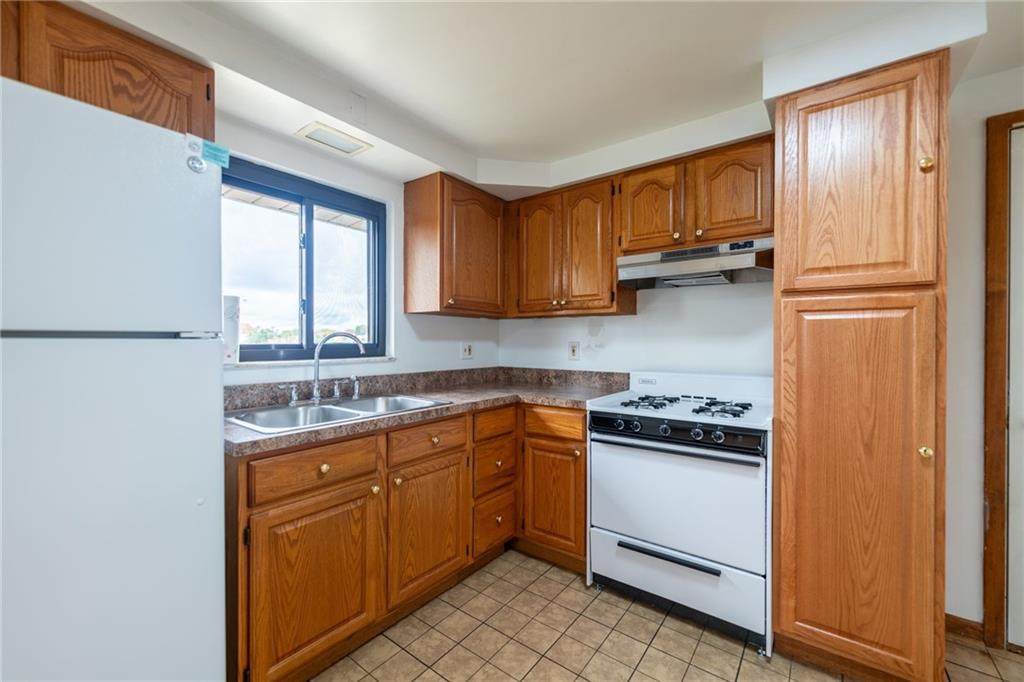 601 Hillcrest Avenue McKees Rocks, PA 15136 - Photo 11 of 32 a kitchen with stainless steel appliances granite countertop a refrigerator sink and cabinets