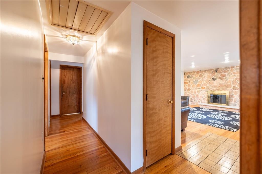 601 Hillcrest Avenue McKees Rocks, PA 15136 - Photo 13 of 32 a view of a hallway with wooden floor and a bathroom