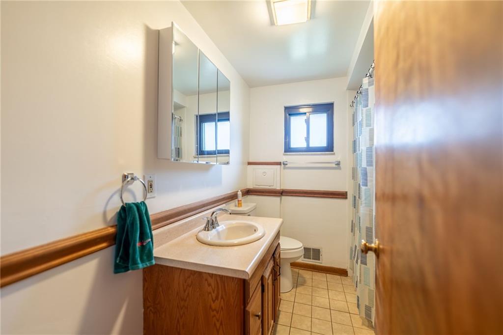 601 Hillcrest Avenue McKees Rocks, PA 15136 - Photo 14 of 32 a bathroom with a sink a toilet and mirror