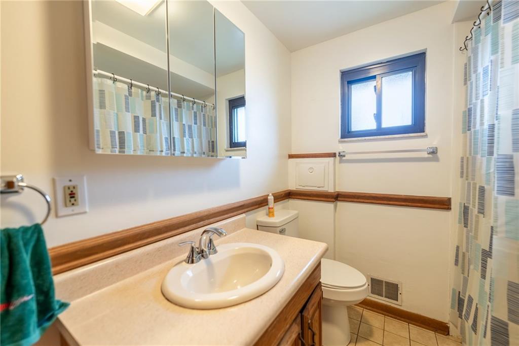 601 Hillcrest Avenue McKees Rocks, PA 15136 - Photo 15 of 32 a bathroom with a sink toilet and mirror