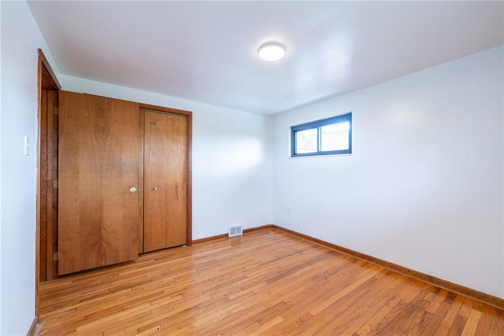 601 Hillcrest Avenue McKees Rocks, PA 15136 - Photo 17 of 32 an empty room with wooden floor and windows